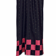 Black sari tab top curtains hung at a window