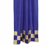 Blue sari tab top curtains hung at a window