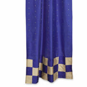 Blue sari tab top curtains hung at a window
