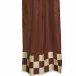 Brown sari tab top curtains hung at a window