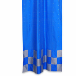 Coral sari tab top curtains hung at a window