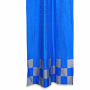 Coral sari tab top curtains hung at a window