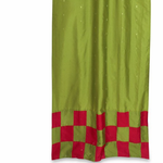 Olive green sari tab top curtains hung at a window