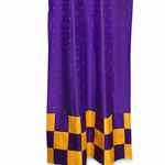 Purple sari tab top curtains hung at a window