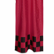 Red sari tab top curtains hung at a window