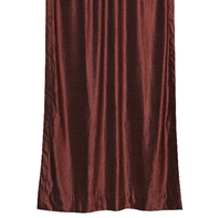 Wine velvet tab top curtains hung at a window