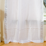 Silver sari tab top curtains hung at a window