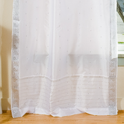 Silver sari tab top curtains hung at a window