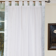 Silver sari tab top curtains hung at a window