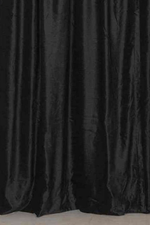 Black velvet tab top curtains hung at a window