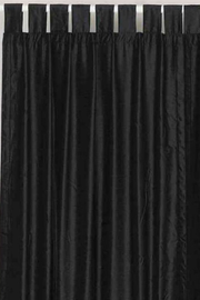 Black velvet tab top curtains hung at a window