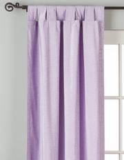 Lavender velvet tab top curtains hung at a window