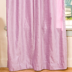 Lilac velvet tab top curtains hung at a window