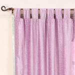 Lilac velvet tab top curtains hung at a window