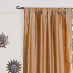 Taupe velvet tab top curtains hung at a window