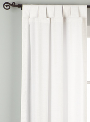White velvet tab top curtains hung at a window