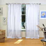 Silver sari tie top curtains hung at a window