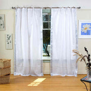 Silver sari tie top curtains hung at a window