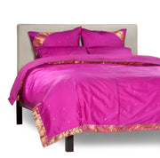 Violet sari duvet cover set made up on a bed