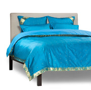 Turquoise sari duvet cover set made up on a bed