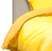 Yellow sari duvet cover set made up on a bed