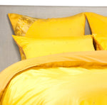 Yellow sari duvet cover set made up on a bed