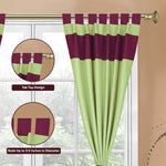 Olive green raw silk tab top curtains hung at a window