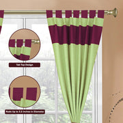 Olive green raw silk tab top curtains hung at a window