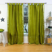 Olive green sari tab top curtains hung at a window
