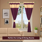 Maroon raw silk tab top curtains hung at a window