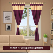 Maroon raw silk tab top curtains hung at a window