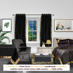 Black sari grommet top curtains hung at a window