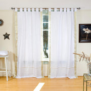 White sari tab top curtains hung at a window