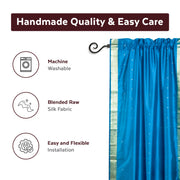 Turquoise sari rod pocket curtains hung at a window