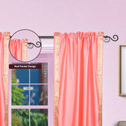 Pink sari rod pocket curtains hung at a window