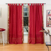 Maroon sari tab top curtains hung at a window