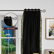 Black sari grommet top curtains hung at a window