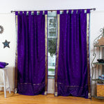 Purple sari tab top curtains hung at a window