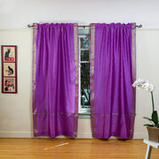 Lavender sari rod pocket curtains hung at a window