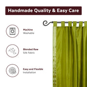 Olive green sari tab top curtains hung at a window