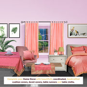 Pink sari tab top curtains hung at a window