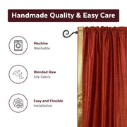 Rust sari rod pocket curtains hung at a window