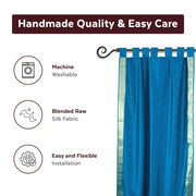 Turquoise sari tab top curtains hung at a window