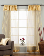 Golden rod sheer tissue rod pocket curtains hung at a window