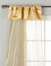 Golden rod sheer tissue rod pocket curtains hung at a window