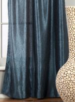 Navy blue sari grommet top curtains hung at a window