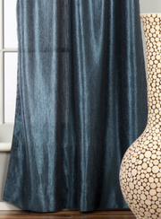 Navy blue sari grommet top curtains hung at a window