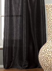Black sari grommet top curtains hung at a window