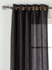 Black sari grommet top curtains hung at a window