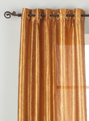 Gold sari grommet top curtains hung at a window